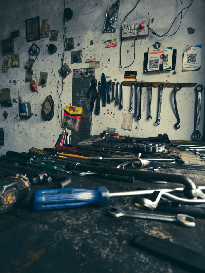creative-03 A detailed view of an organized workshop filled with various hand tools on a workbench.